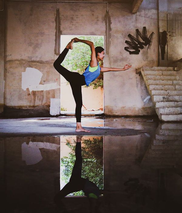An empty yoga mat in a serene room with natural light, ready for practice.